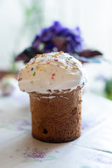 Easter cake on flower and eggs background. Spring season.  Easter composition of sweet bread, paska, eggs and flower. Orthodox tradition. Selective focus. 