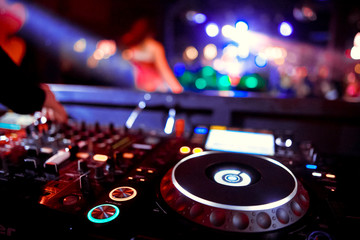 Fototapeta na wymiar DJ playing music at mixer closeup