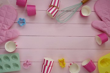 Easter baking.Baking Tools. Silicone Forms with Easter Symbols, muffin cup, cookie cutters  on a light pink wooden background.Easter season