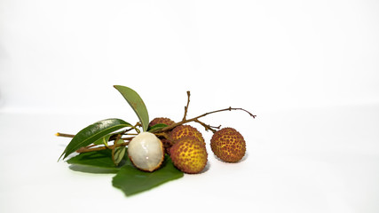 Lychee and green leaves, white background