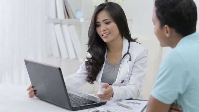 beautiful female doctor talk to her patient about some prescription