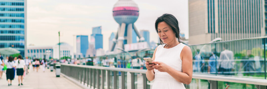 Phone Asian Businesswoman Texting Online In China Banner Panorama. Middle Aged Woman Using Cellphone On Shanghai City Street. Mature People Lifestyle. Businesswoman Holding Mobile Phone Working.