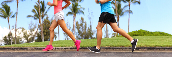 Runners legs sprinting outdoors banner- Sportive people racing running in park, closeup of running shoes. Healthy lifestyle and sport concept panorama crop.