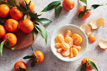 Fresh tangerines with stems and leaves