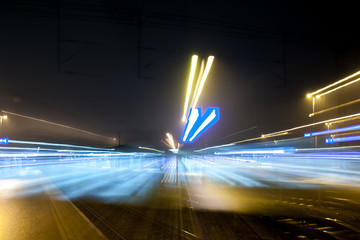 Fototapeta na wymiar Abstract night scene of Kouvola railway station in zoom blur effect.