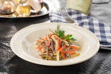 Beef salad with fresh tomatoes, bell pepper and pear served for lunch on the table