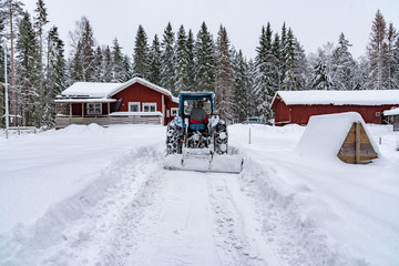 old blue fordson dexta tractor plowing snow