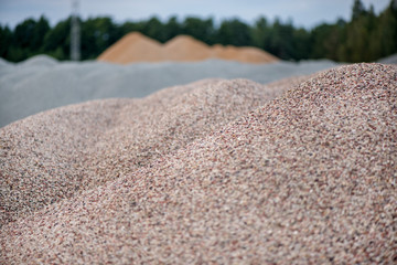 Large piles of construction sand and gravel used for asphalt production and building. Limestone quarry, mining rocks and stones 