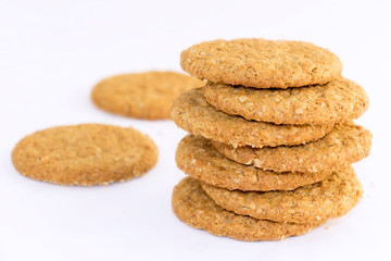 Homemade shortbread cookies made of oatmeal are stacked on a white table background. Food snack concept and with copy space for text.