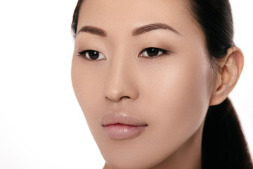 Obraz premium close-up portrait of beautiful young asian woman on white background closeup. girl with clean skin