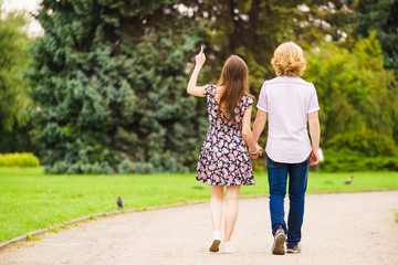 Man and woman holding hands in park