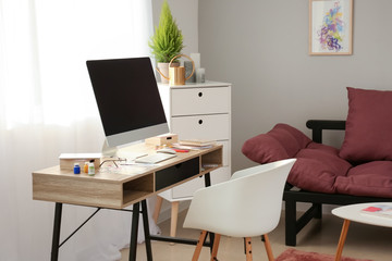 Interior of room with comfortable designer workplace
