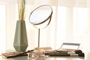 Dressing table with professional makeup cosmetics and eyelash curler