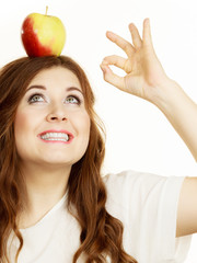 Woman funny girl holds on head apple fruit