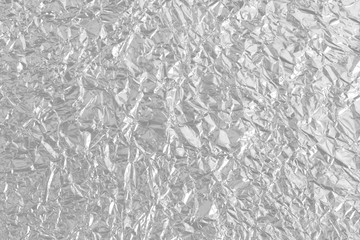 Shiny silver foil metal texture, abstract gray wrapping paper for background and design art work.