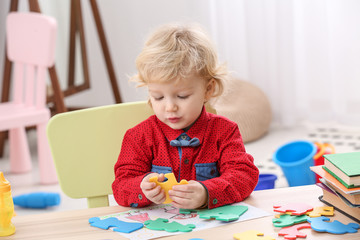 Cute little boy playing at home