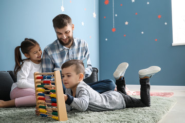 Young father with his children playing at home