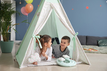 Cute little children lying in hovel at home © Pixel-Shot