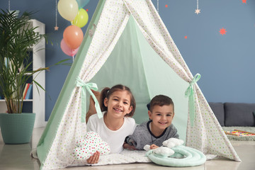 Cute little children lying in hovel at home © Pixel-Shot