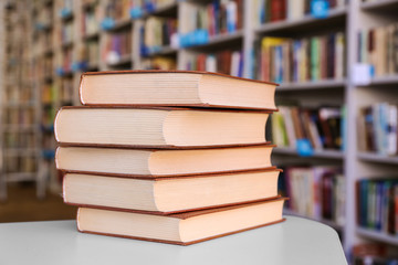 Stack of books on table in library