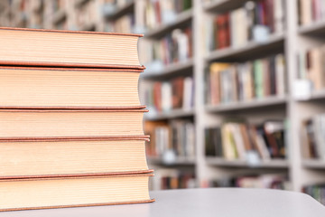 Stack of books on table in library