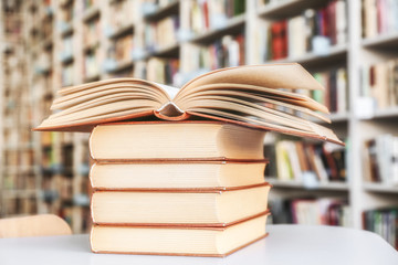 Stack of books on table in library