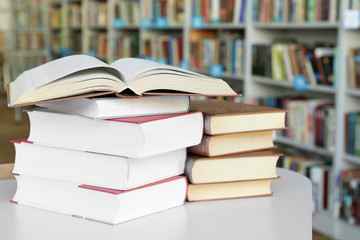 Many books on table in library