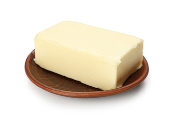 Plate with butter on white background