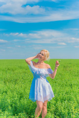 Woman on a nature, spring - summer season, concept of freedom life, lady in white linen dress 