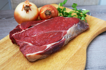 Fresh raw beef steak  on wooden background, top view 