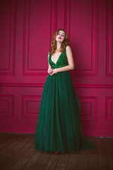 Gorgeous woman in green evening long dress, inspiration fashionable clothes for ladies. Vintage hairstyle and make up