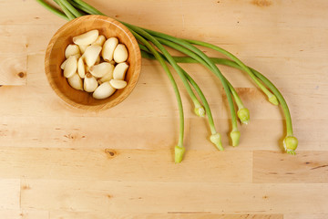 Garlic Flower bud green stem on wood background