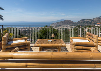 Armchairs and table on the terrace overlooking the Bay of Naples and  Vesuvius. Sorrento. Italy
