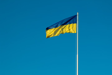 Ukrainian flag on blue sky background