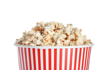 Paper cup of tasty popcorn on white background, closeup