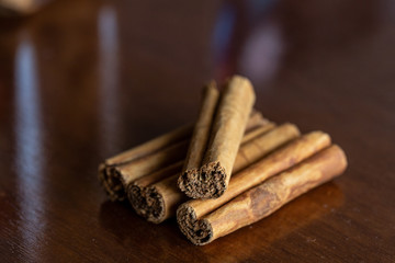 Cinnamon pile on dark wood table