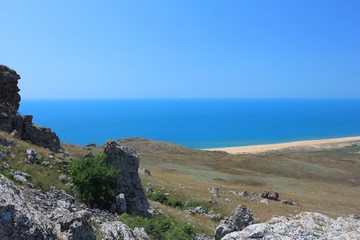 the distant wild beach beyond the mountain