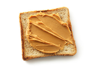 Toasted bread with tasty peanut butter on white background