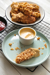 Tasty nuggets with sauce on table