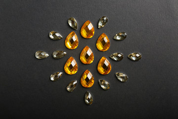 Composition with precious stones for jewellery on dark background