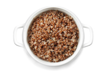 Pot with tasty boiled buckwheat on white background