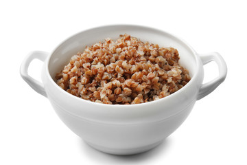 Pot with tasty boiled buckwheat on white background