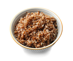 Bowl with tasty boiled buckwheat on white background