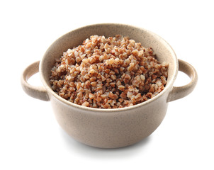 Pot with tasty boiled buckwheat on white background