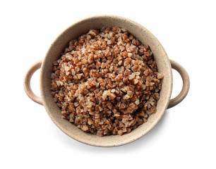 Pot with tasty boiled buckwheat on white background
