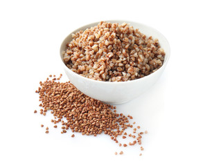 Bowl with tasty boiled buckwheat on white background