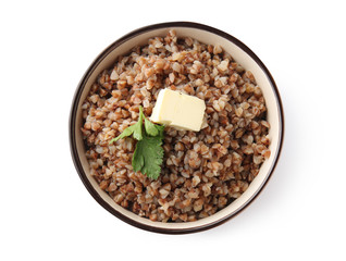 Bowl with tasty boiled buckwheat on white background