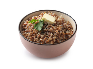 Bowl with tasty boiled buckwheat on white background