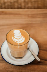 Nice cups of hot Coffee Latte art on wood table