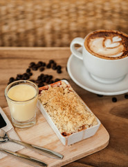 Berry and apple crumble on wood tray with hot latte coffee